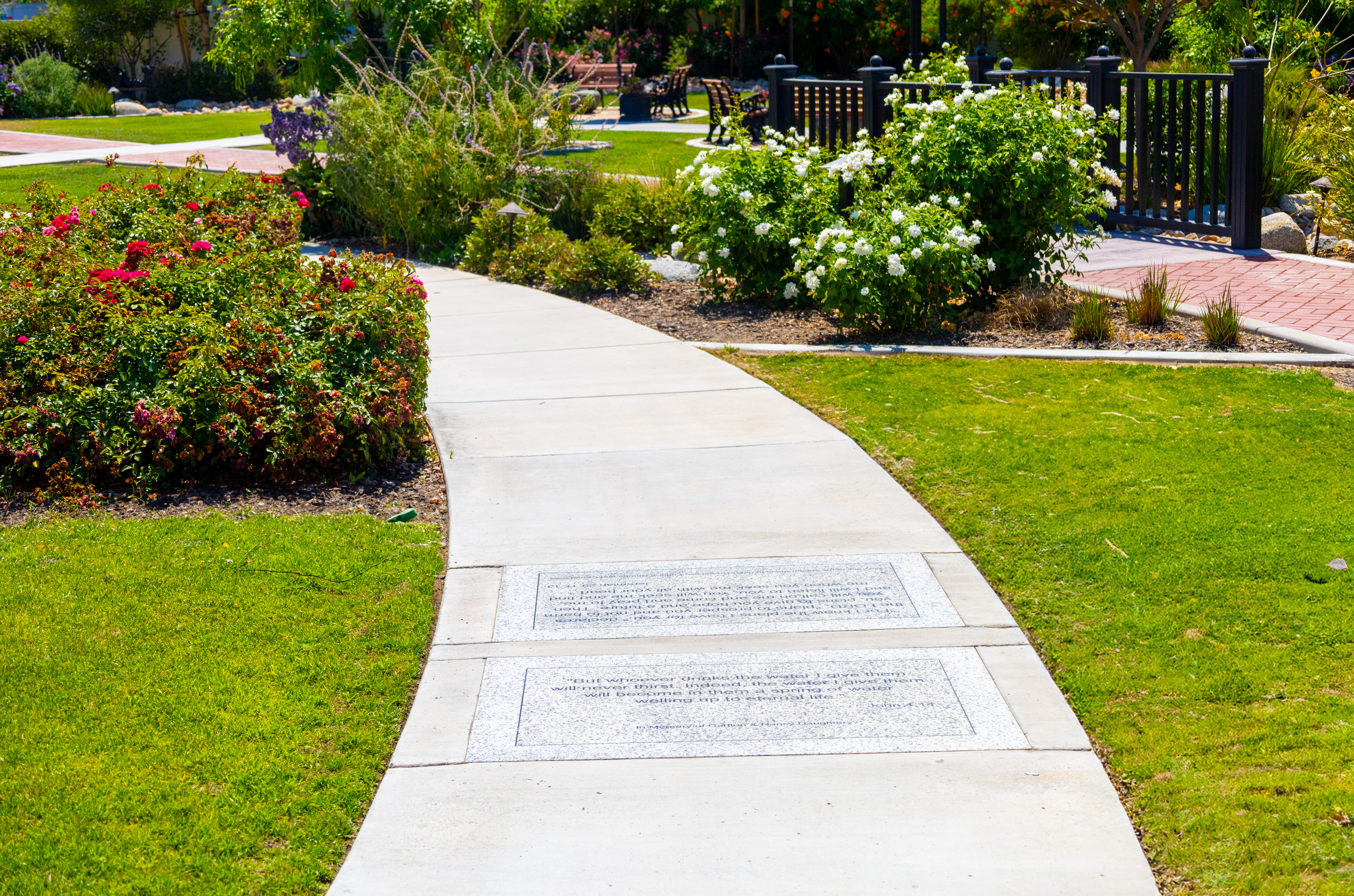Hoffmann Hospice pathway with engraved memorial stones surrounded by lush gardens